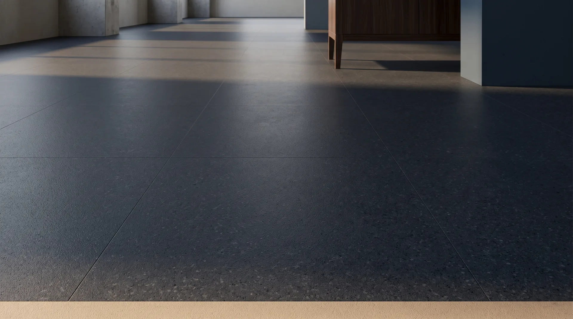 Close-up of dark charcoal porcelain tile with a fine matte texture and straight grout lines