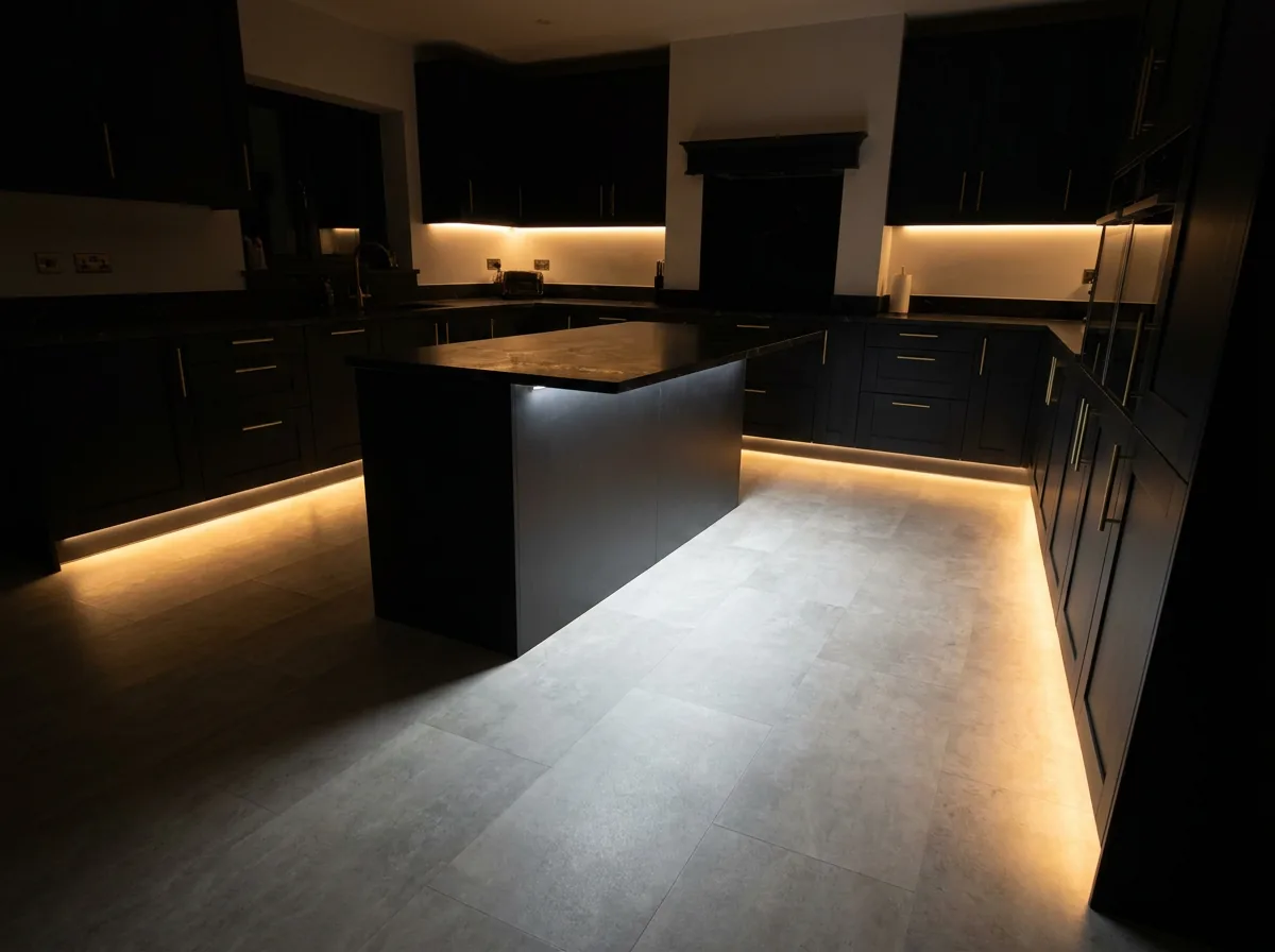 Pale grey stone-look porcelain tile laid in a dark kitchen with black cabinets